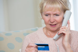 Credit Card Scam:Senior Woman Giving Credit Card Details On The Phone